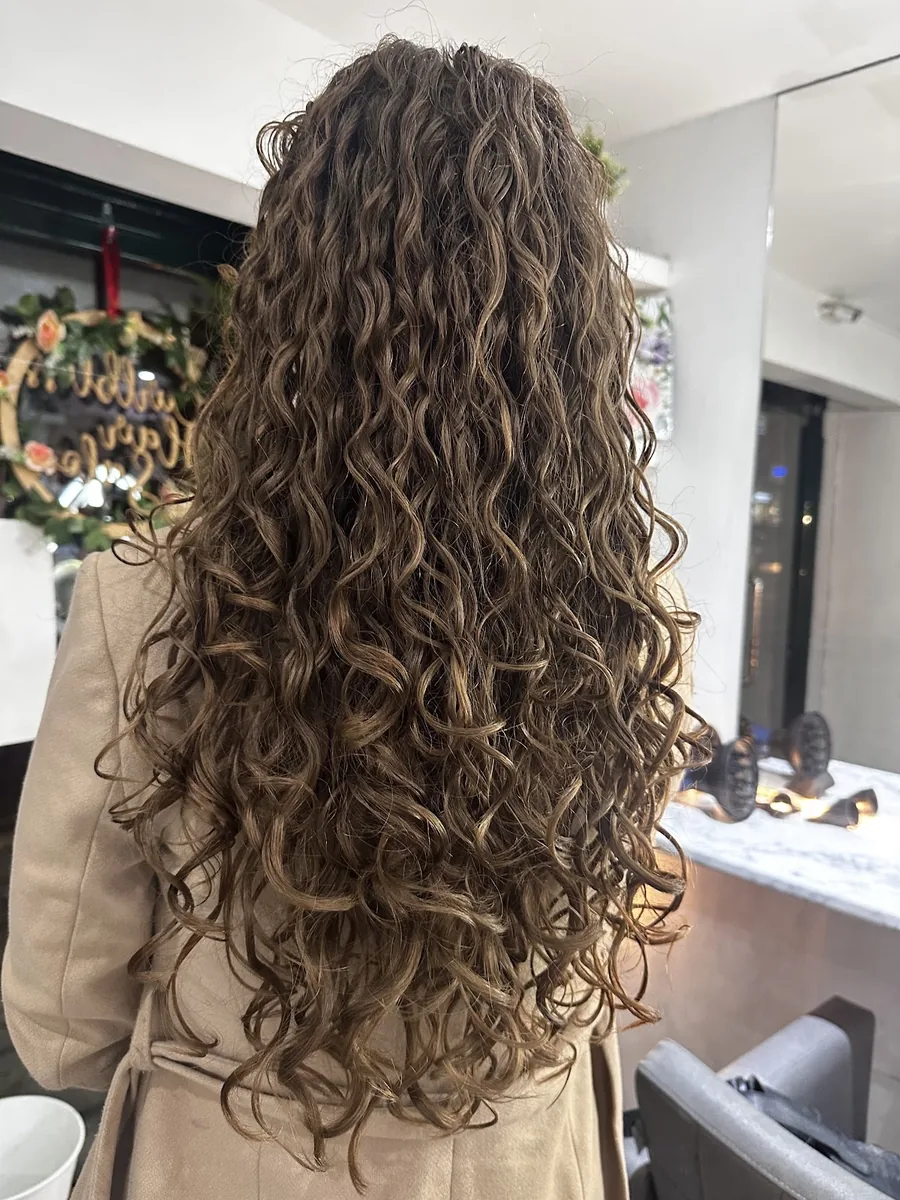 Very long brown curls reaching the lower back, shot down the salon floor